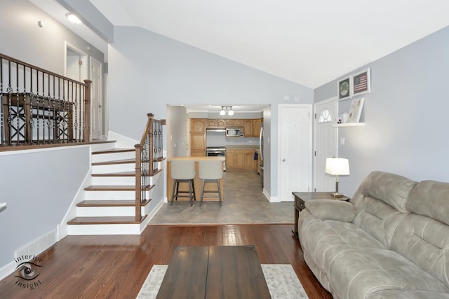 7027 174th Pl, Tinley Park, IL 60477 - living area featuring vaulted ceiling, stairway, and wood finished floors