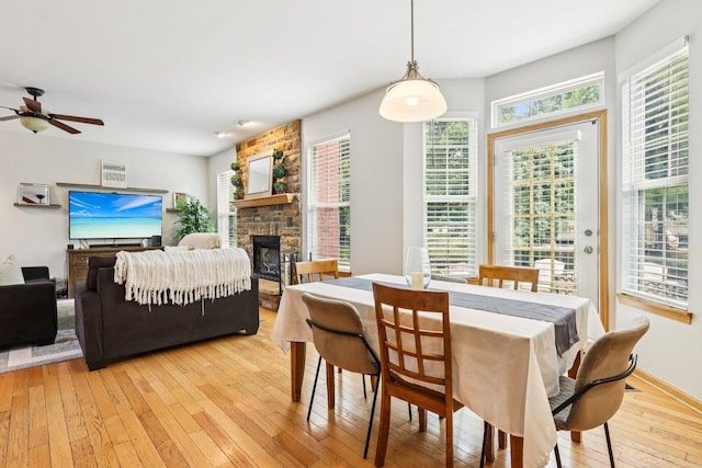 1271 Mcdole Dr, Sugar Grove, IL 60554 - dining area with a fireplace, ceiling fan, light wood-style flooring, and plenty of natural light