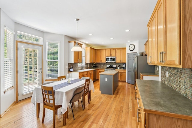 1271 Mcdole Dr, Sugar Grove, IL 60554 - kitchen with appliances with stainless steel finishes, backsplash, light wood-type flooring, a center island, and recessed lighting