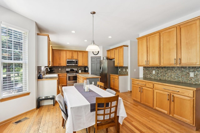1271 Mcdole Dr, Sugar Grove, IL 60554 - kitchen with appliances with stainless steel finishes, tasteful backsplash, light wood-type flooring, recessed lighting, and a center island