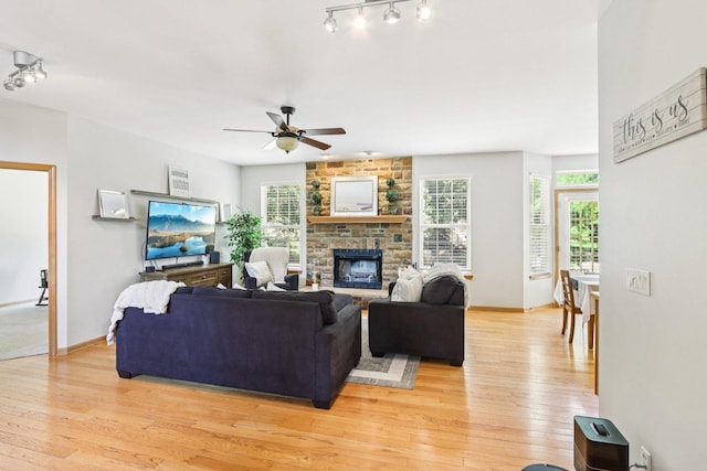 1271 Mcdole Dr, Sugar Grove, IL 60554 - living room with light wood-style flooring, ceiling fan, a stone fireplace, and track lighting
