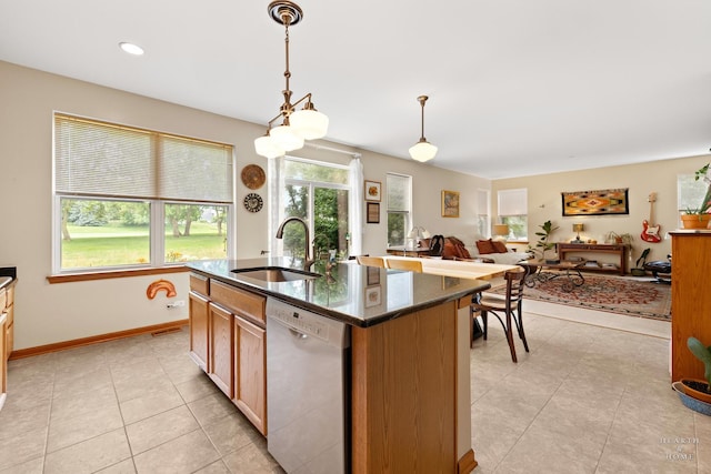 365 Oakmont Dr, Cary, IL 60013 - kitchen with dishwasher, light tile patterned floors, an island with sink, dark stone counters, and hanging light fixtures