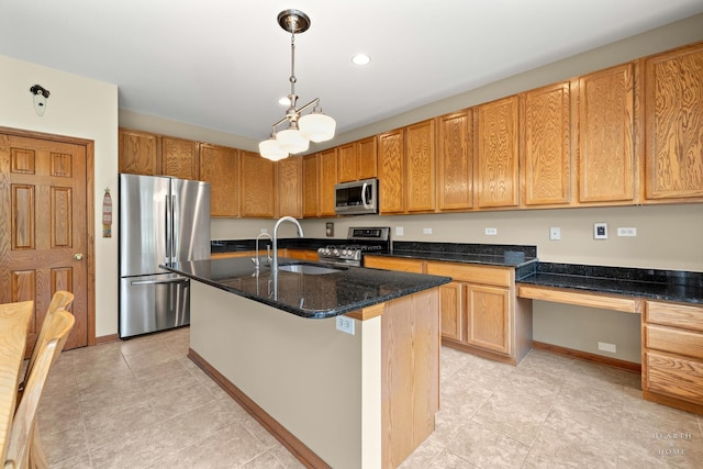 365 Oakmont Dr, Cary, IL 60013 - kitchen featuring stainless steel appliances, light tile patterned floors, dark stone counters, an island with sink, and decorative light fixtures