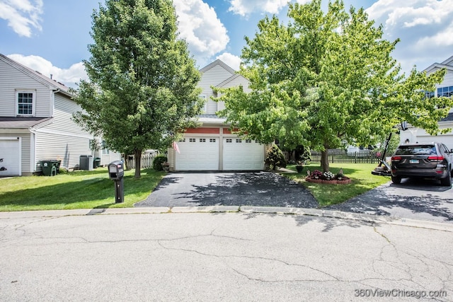 2325 N Lenox Ct, Round Lake Beach, IL 60073 - view of property hidden behind natural elements featuring asphalt driveway and a garage