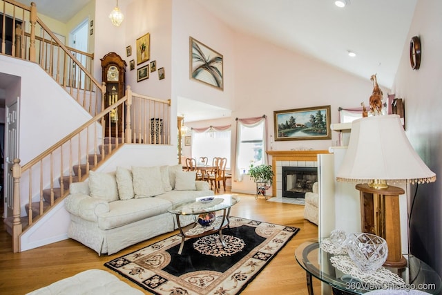 2325 N Lenox Ct, Round Lake Beach, IL 60073 - living area with stairway, wood finished floors, high vaulted ceiling, recessed lighting, and a fireplace
