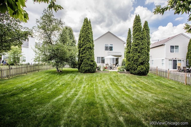 2325 N Lenox Ct, Round Lake Beach, IL 60073 - back of property featuring a patio and a fenced backyard