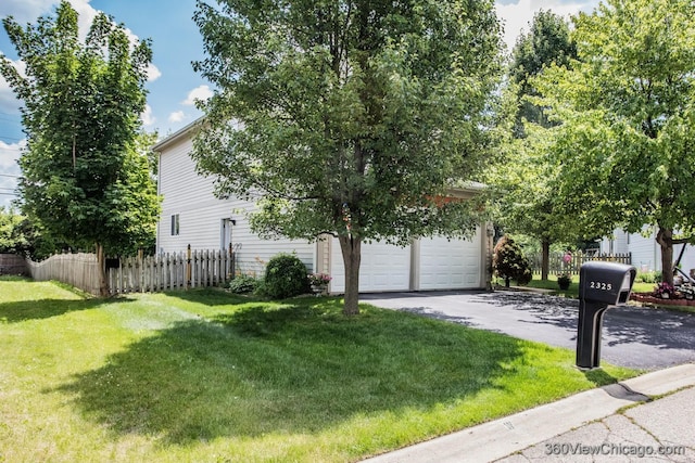 2325 N Lenox Ct, Round Lake Beach, IL 60073 - view of side of property with a garage and asphalt driveway