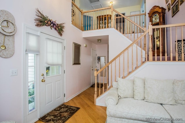 2325 N Lenox Ct, Round Lake Beach, IL 60073 - entryway with wood finished floors, stairway, and a high ceiling