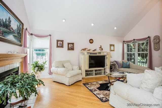 2325 N Lenox Ct, Round Lake Beach, IL 60073 - living area with lofted ceiling, light wood-type flooring, a tiled fireplace, and recessed lighting
