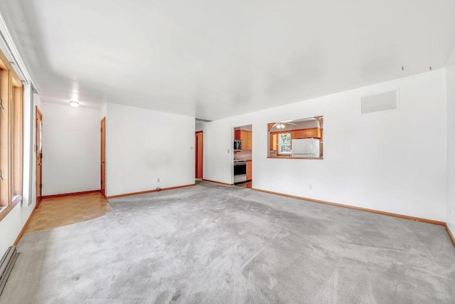 556 W River St, Bourbonnais, IL 60914 - unfurnished living room featuring light carpet and baseboards
