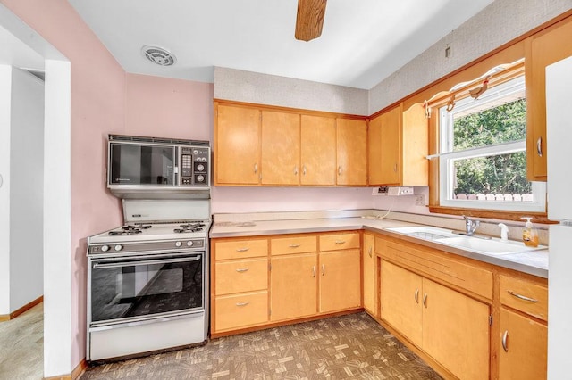 556 W River St, Bourbonnais, IL 60914 - kitchen with black microwave, white range, light countertops, light floors, and a ceiling fan