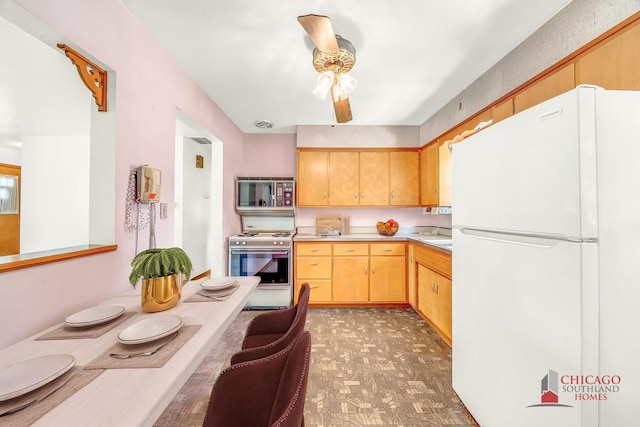 556 W River St, Bourbonnais, IL 60914 - kitchen with white appliances, light countertops, a ceiling fan, and light floors