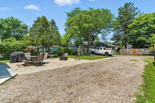 1518 Lucia Ave, Waukegan, IL 60085 - view of yard featuring a shed, a patio, and an outdoor fire pit