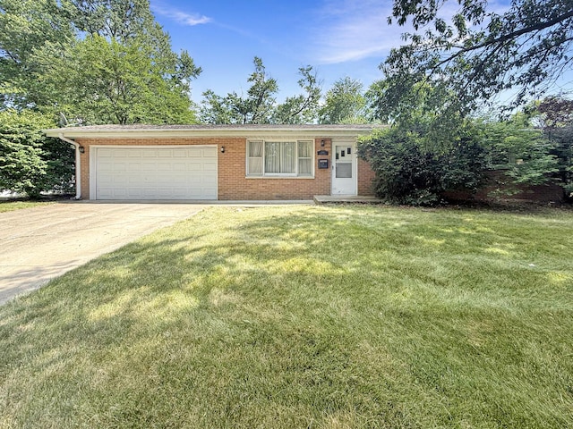 1340 Jeffrey Dr, Rantoul, IL 61866 - view of front facade with brick siding, an attached garage, driveway, and a front yard