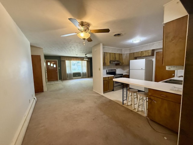 1340 Jeffrey Dr, Rantoul, IL 61866 - kitchen with electric range, ceiling fan, freestanding refrigerator, brown cabinetry, and under cabinet range hood