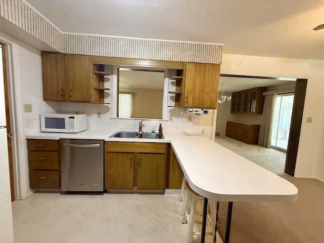 1340 Jeffrey Dr, Rantoul, IL 61866 - kitchen featuring stainless steel dishwasher, white microwave, open shelves, and brown cabinetry