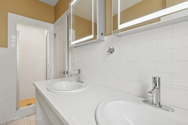 6101 N Sheridan Rd Unit 11C, Chicago, IL 60660 - bathroom with a stall shower, decorative backsplash, double vanity, and tile walls