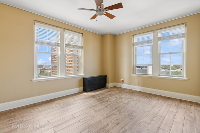6101 N Sheridan Rd Unit 11C, Chicago, IL 60660 - unfurnished room with cooling unit, light wood-style flooring, plenty of natural light, a ceiling fan, and crown molding