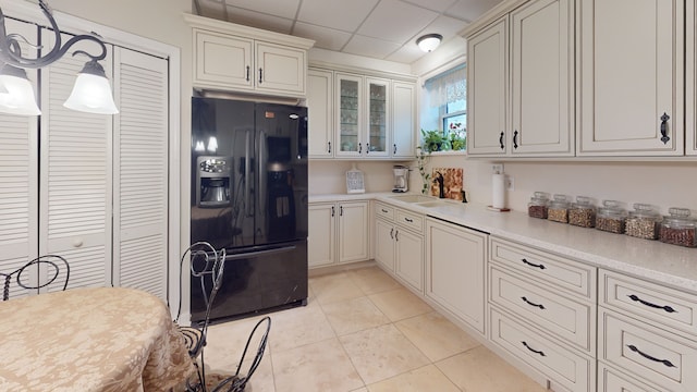 315 E Union Ave, Wheaton, IL 60187 - kitchen with black refrigerator with ice dispenser, glass insert cabinets, light countertops, light tile patterned flooring, and a drop ceiling