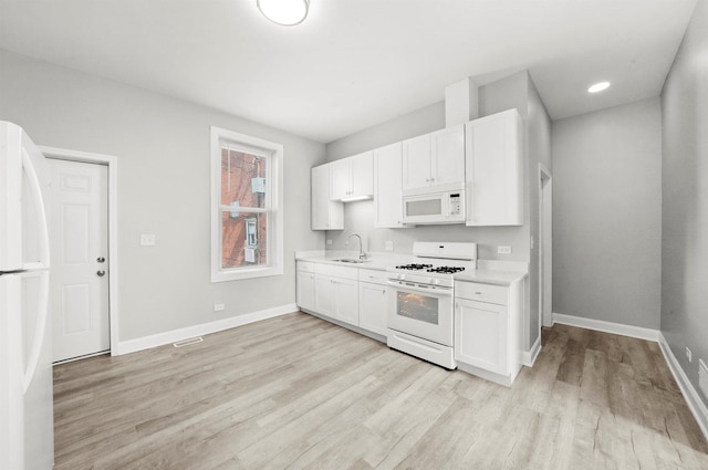 5401 W 22nd Pl, Cicero, IL 60804 - kitchen featuring white appliances, light countertops, light wood-style floors, white cabinets, and recessed lighting