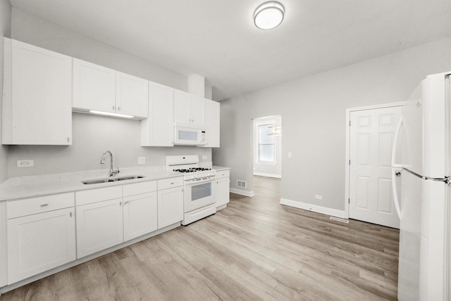 5401 W 22nd Pl, Cicero, IL 60804 - kitchen with white appliances, light wood finished floors, white cabinetry, and light countertops