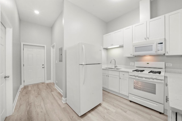 5401 W 22nd Pl, Cicero, IL 60804 - kitchen with white appliances, light wood-style flooring, light countertops, and white cabinets