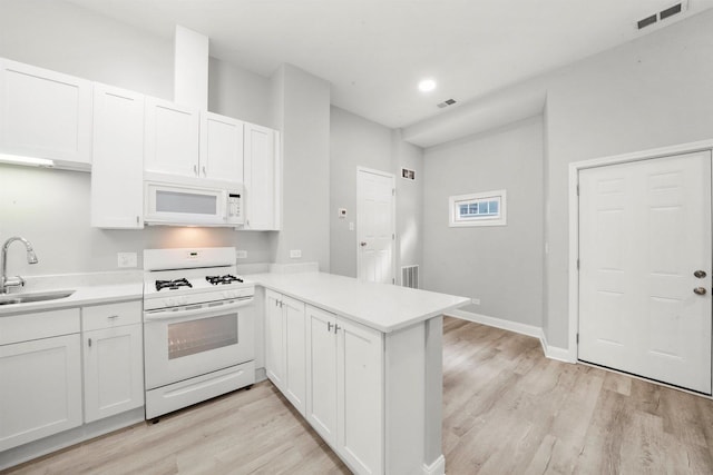 5401 W 22nd Pl, Cicero, IL 60804 - kitchen with white appliances, a peninsula, light wood-style flooring, light countertops, and recessed lighting
