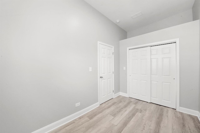 5401 W 22nd Pl, Cicero, IL 60804 - unfurnished bedroom featuring light wood-style flooring, a closet, and lofted ceiling