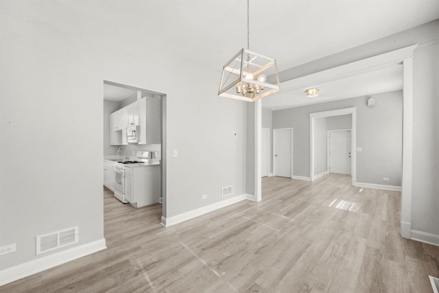 5401 W 22nd Pl, Cicero, IL 60804 - unfurnished dining area featuring light wood finished floors and a chandelier