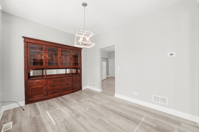 5401 W 22nd Pl, Cicero, IL 60804 - unfurnished dining area featuring light wood-type flooring and a chandelier