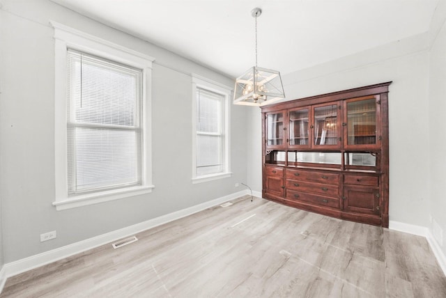5401 W 22nd Pl, Cicero, IL 60804 - unfurnished dining area with a chandelier and light wood-style floors