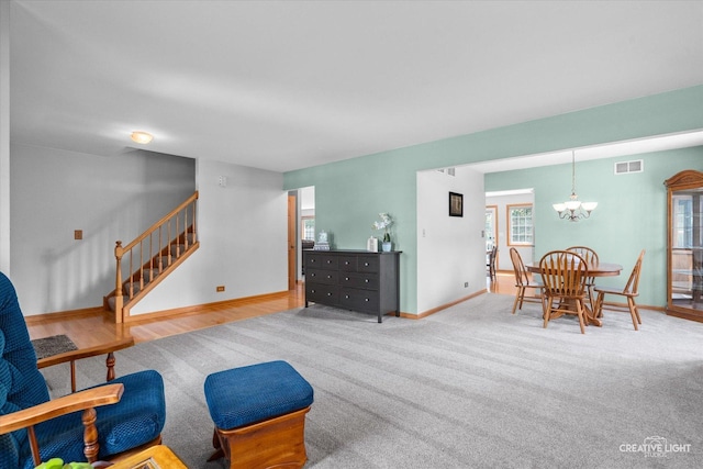 210 Fox Chase Dr N, Oswego, IL 60543 - living area with a chandelier, carpet flooring, and stairs