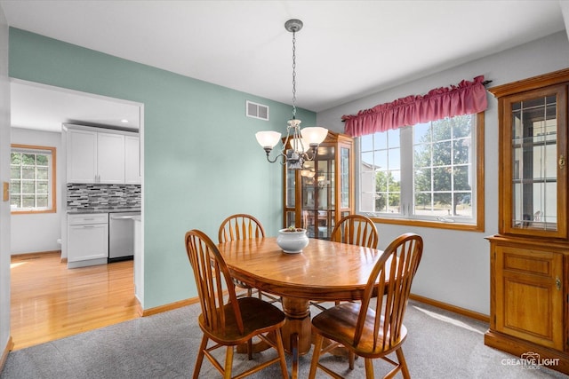 210 Fox Chase Dr N, Oswego, IL 60543 - dining area featuring a chandelier and light carpet