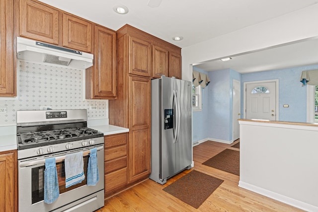 108 6th St, Downers Grove, IL 60515 - kitchen with appliances with stainless steel finishes, under cabinet range hood, light countertops, light wood-style floors, and brown cabinets