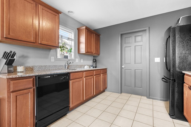 3034 Warwickshire Dr, Machesney Park, IL 61115 - kitchen featuring black appliances, brown cabinets, light stone countertops, and light tile patterned floors