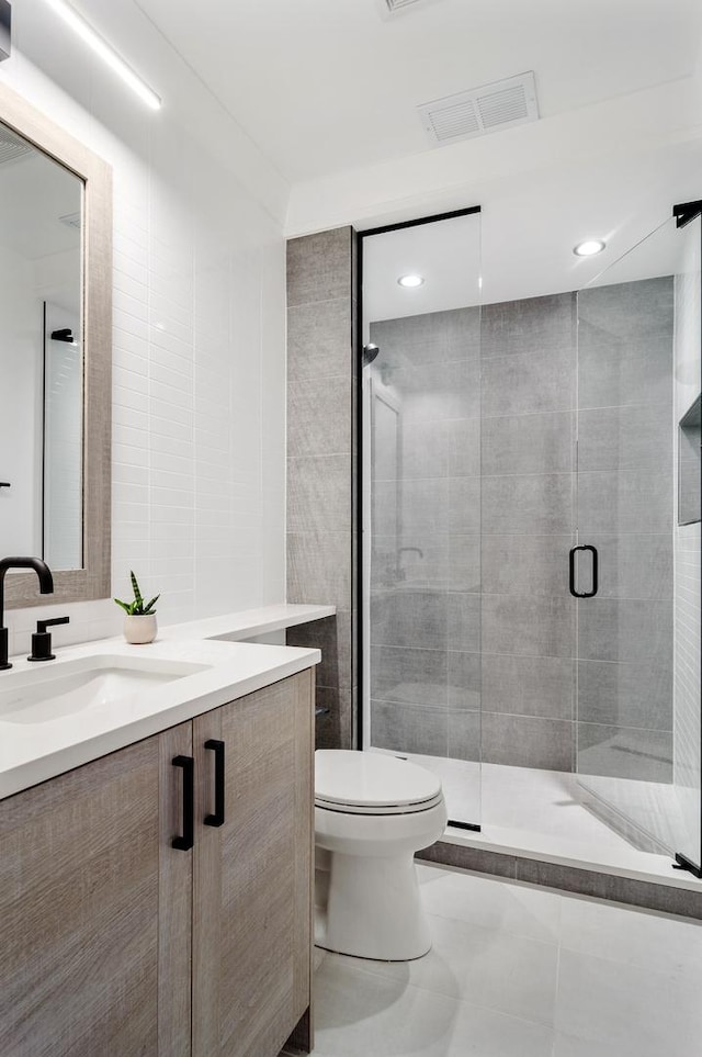 1116 W Addison St, Chicago, IL 60613 - full bathroom featuring tile walls, vanity, a shower stall, and tile patterned floors