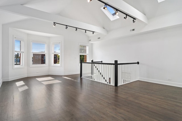 1116 W Addison St, Chicago, IL 60613 - spare room featuring track lighting, vaulted ceiling, a skylight, and wood finished floors