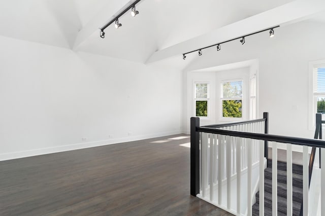 1116 W Addison St, Chicago, IL 60613 - empty room featuring track lighting, lofted ceiling, and dark wood-type flooring