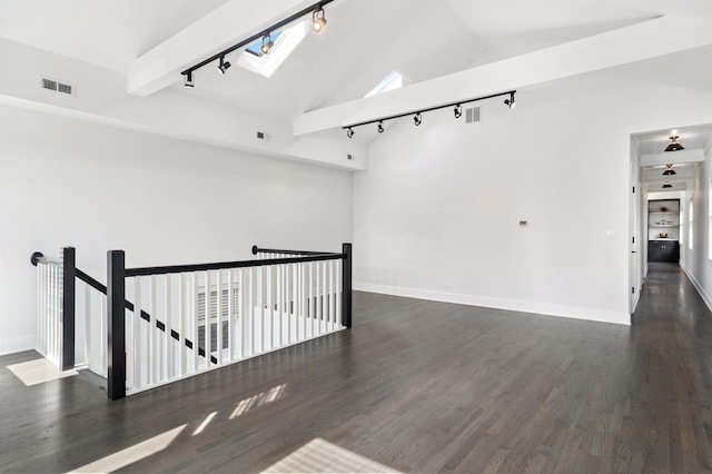 1116 W Addison St, Chicago, IL 60613 - unfurnished room with rail lighting, lofted ceiling, a skylight, and wood finished floors