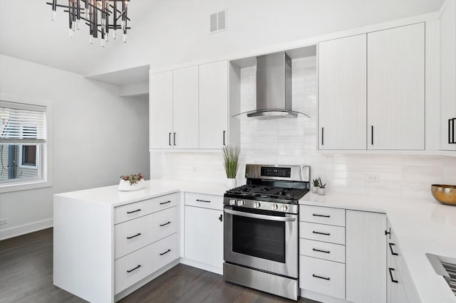 1116 W Addison St, Chicago, IL 60613 - kitchen featuring wall chimney range hood, stainless steel gas stove, a peninsula, backsplash, and light countertops