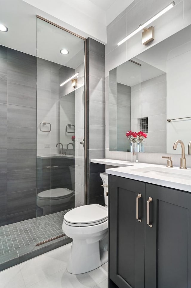 1116 W Addison St, Chicago, IL 60613 - bathroom with tile walls, tile patterned flooring, a shower stall, vanity, and recessed lighting