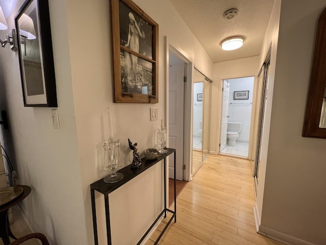 230 E Ontario St Unit 905, Chicago, IL 60611 - hall featuring light wood finished floors and a textured ceiling