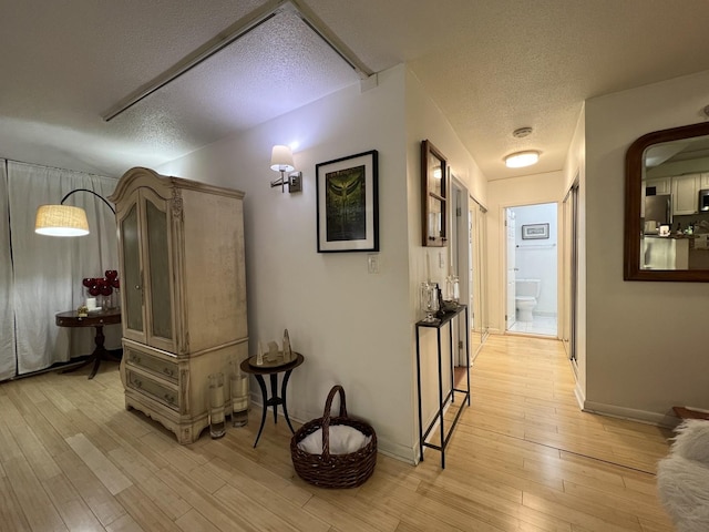 230 E Ontario St Unit 905, Chicago, IL 60611 - corridor featuring a textured ceiling and light wood-style flooring