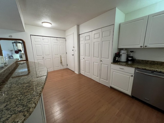 230 E Ontario St Unit 905, Chicago, IL 60611 - kitchen with dishwasher, wood finished floors, a textured ceiling, white cabinets, and dark stone countertops