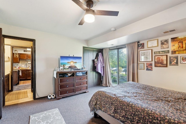 15810 Il Route 173 Unit 1D, Harvard, IL 60033 - carpeted bedroom with access to outside, ceiling fan, and ensuite bath