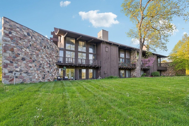 15810 Il Route 173 Unit 1D, Harvard, IL 60033 - back of house with a chimney and a yard