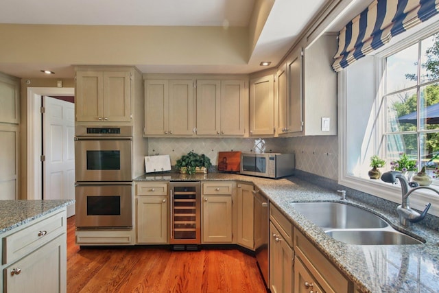 13 Wind Ridge Rd, South Barrington, IL 60010 - kitchen with stainless steel appliances, beverage cooler, backsplash, light wood finished floors, and light stone countertops