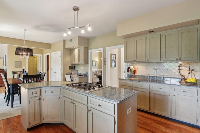 13 Wind Ridge Rd, South Barrington, IL 60010 - kitchen with stainless steel gas stovetop, dark wood-type flooring, a kitchen island, backsplash, and light stone countertops