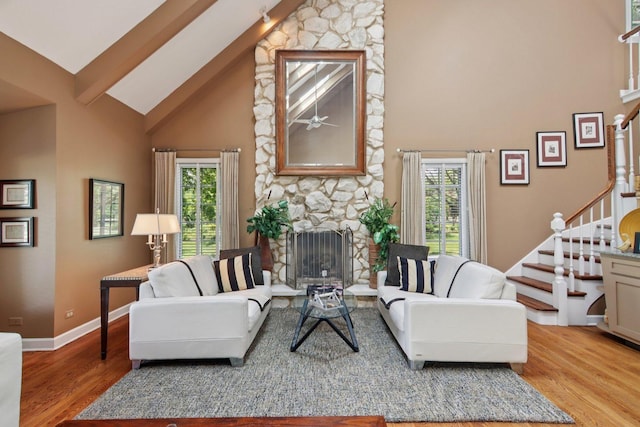 13 Wind Ridge Rd, South Barrington, IL 60010 - living room with high vaulted ceiling, stairway, wood finished floors, a stone fireplace, and beam ceiling