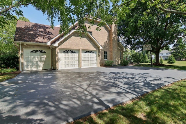 13 Wind Ridge Rd, South Barrington, IL 60010 - view of front of home featuring driveway, an attached garage, and a chimney